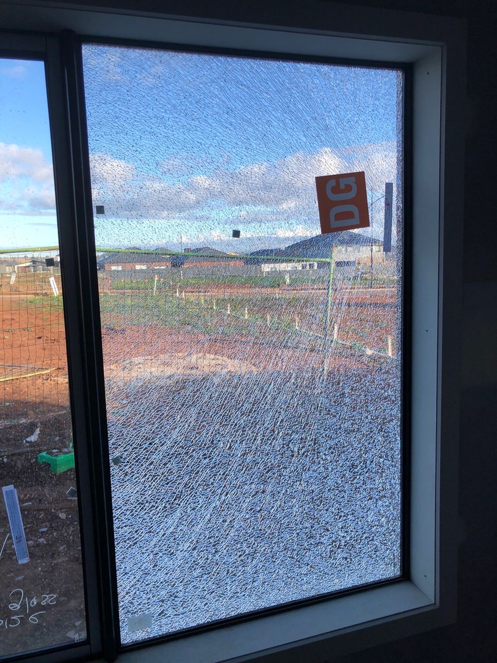 Cracked window glass that has to be replaced before the painters start, found during a fixing inspection in Truganina