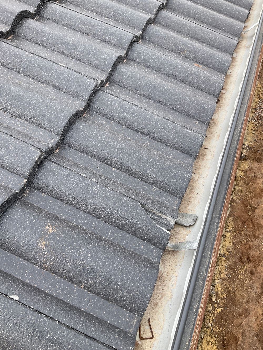 Cracked roof tiles found at lock-up that will let water through, found during a lock-up inspection in Truganina