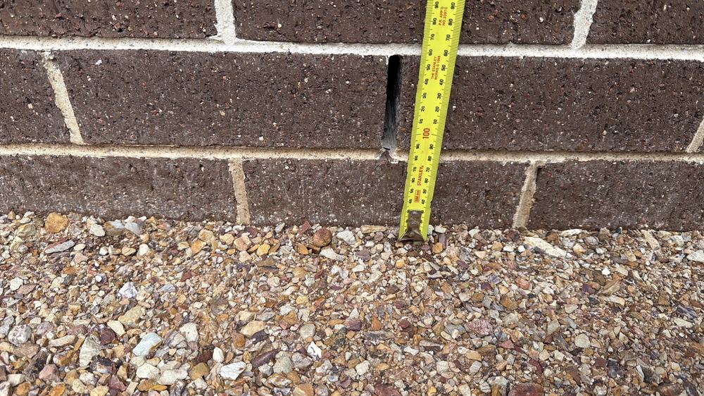 Cladding within 150mm of the soil, inviting damp and hidden termite entry, found during a construction stage inspection in Truganina